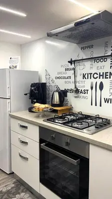 a kitchen with a stove and a refrigerator at Life Rooms in Misilmeri