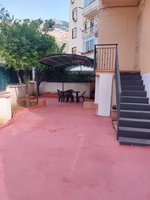 a red carpeted patio with a picnic table and stairs at Kalisa Home, B&B e Casa Vacanza Palermo in Capaci