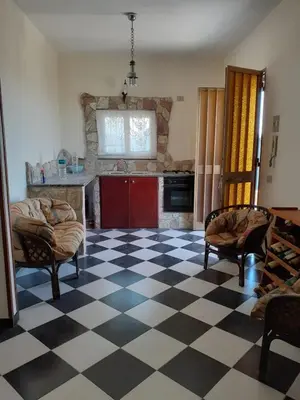 a living room with a black and white checkered floor at Casa vacanze zina in Altavilla Milicia