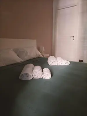 a group of towels are lined up on a bed at Thalia in Palermo