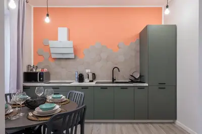 a kitchen with a table and a refrigerator at LE PORTE DEL KASSARO in Palermo
