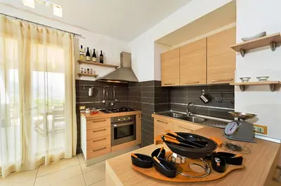 a kitchen with a table with pots and pans on it at Villa MiraScopello in Castellammare del Golfo