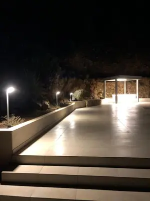 a walkway lit up at night with street lights at Villa MiraScopello in Castellammare del Golfo