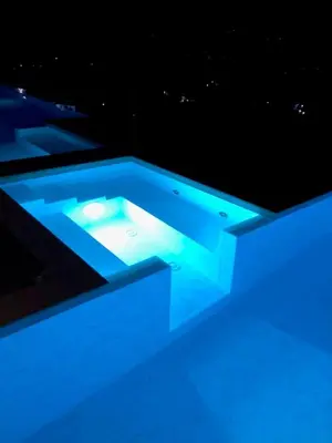 a swimming pool with blue lights in the dark at Villa MiraScopello in Castellammare del Golfo