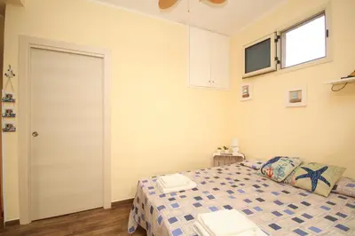 a bedroom with a bed and a window and a door at La casa di Jack in Bagheria