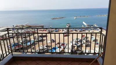 a balcony with a view of a beach and the ocean at La casa di Jack in Bagheria