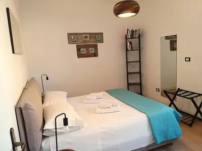 a room with a bed with towels on it at La Porta dei Mori in Palermo