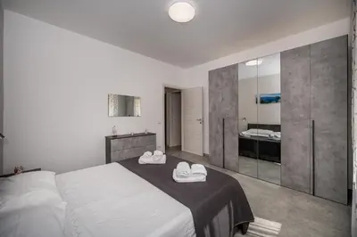 a bedroom with a bed with white towels on it at Golden House con jacuzzi in Castellammare del Golfo
