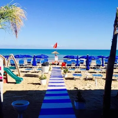 a blue and white striped pathway on the beach at Golden House con jacuzzi in Castellammare del Golfo