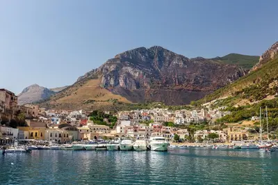 a group of boats docked in a harbor with mountains at Golden House con jacuzzi in Castellammare del Golfo