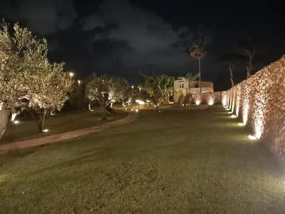 a wall with lights in a park at night at Villa Albamonte in Carini