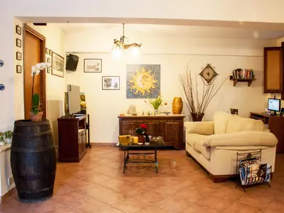 a living room with a couch and a barrel at Bed And Breakfast Maria in Scopello