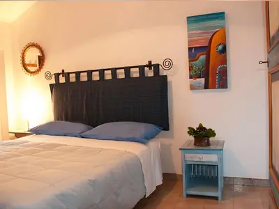 a bedroom with a bed and a picture on the wall at Bed And Breakfast Maria in Scopello