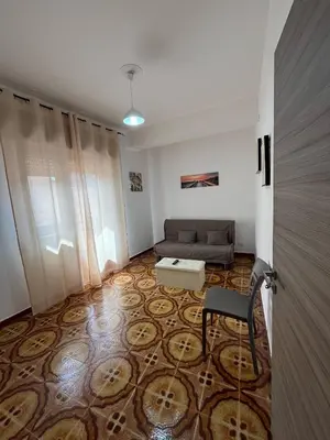 a living room with a couch and a chair at Casa Vacanza Randazzo in Trappeto