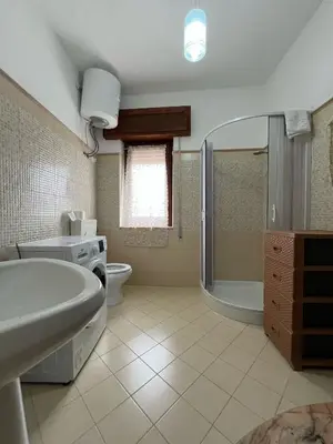 a bathroom with a tub and a toilet and a sink at Casa Vacanza Randazzo in Trappeto