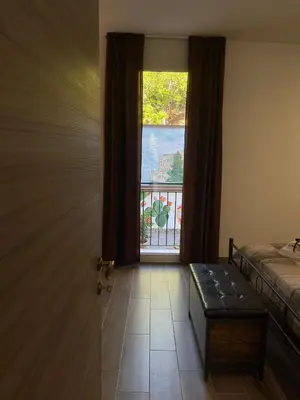 a room with a window and a bed and a table at La Casa Dei Cavalieri in Caccamo