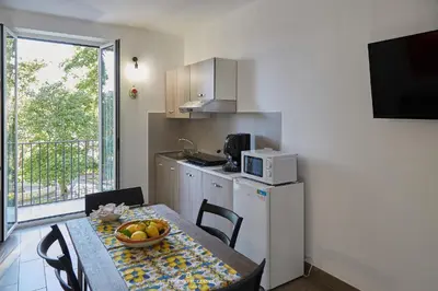 a kitchen with a table with a bowl of fruit on it at La Casa Dei Cavalieri in Caccamo