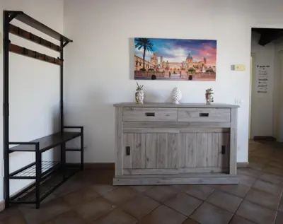 a wooden dresser in a room with a picture on the wall at La Casa di Filippo in Palermo