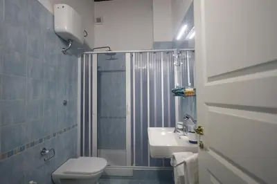 a bathroom with a toilet and a sink and a shower at La Casa di Filippo in Palermo