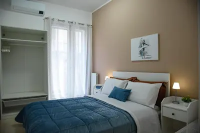a bedroom with a bed with a blue blanket and a window at Kalsa Casa dei Mori in Palermo