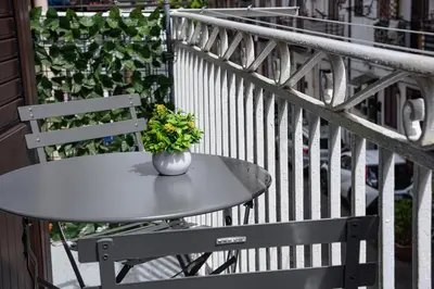 a vase of flowers sitting on a table on a balcony at Kalsa Casa dei Mori in Palermo