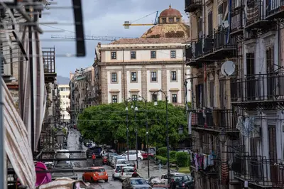 a city street with a building with a dome at Kalsa Casa dei Mori in Palermo