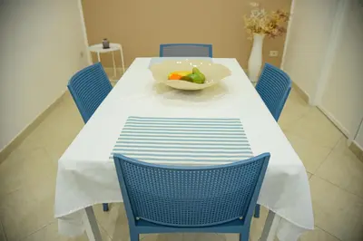 a dining room table with a bowl of fruit on it at Kalsa Casa dei Mori in Palermo