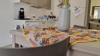 a table with a vase on top of it in a kitchen at Holiday House Lady in Terrasini