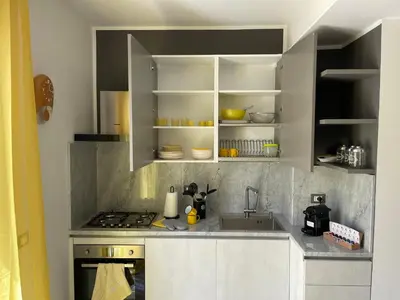 a kitchen with a sink and a stove top oven at La Terrazza del Capo in San Vito lo Capo