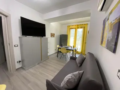 a living room with a couch and a flat screen tv at La Terrazza del Capo in San Vito lo Capo