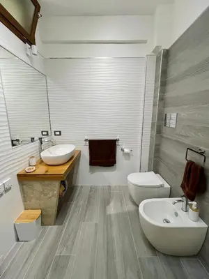 a bathroom with a sink and a toilet and a tub at La Terrazza del Capo in San Vito lo Capo