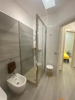 a bathroom with a glass shower and a sink at La Terrazza del Capo in San Vito lo Capo