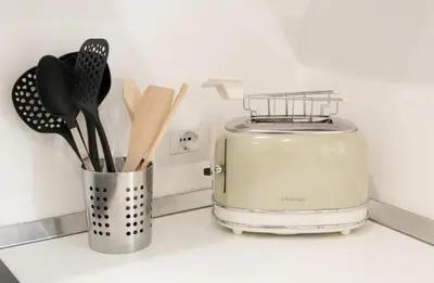 a kitchen counter with a toaster and utensils at Holiday House Monalisa in Terrasini