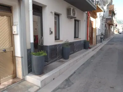 a row of potted plants on the side of a building at Holiday House Monalisa in Terrasini