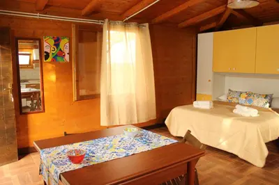 a bedroom with a bed and a table in it at Il giardino di Mondello in Mondello