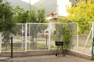 a wire fence with a chicken in a cage at Il giardino di Mondello in Mondello