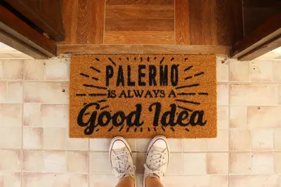 a pair of shoes on a tile floor with a sign at Il giardino di Mondello in Mondello