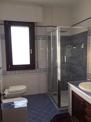 a bathroom with a shower and a toilet and a sink at Mondello Luxury Apartment on the Beach in Mondello