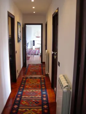 a hallway with rugs on the floor of a house at Mondello Luxury Apartment on the Beach in Mondello