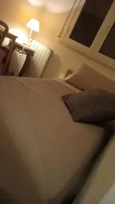 a bed in a bedroom next to a lamp at Nido del falco in Mondello