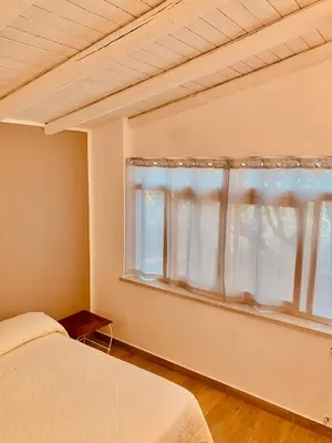a bedroom with a bed and a window at La Murgiulina in Carini