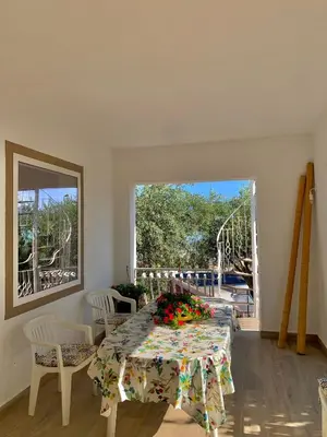 a dining room with a table with flowers on it at La Murgiulina in Carini