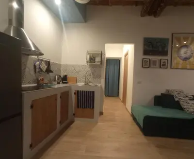 a kitchen and living room with a sink and a bed at PalermHost in Palermo