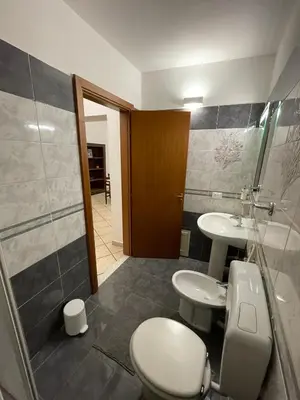 a bathroom with a toilet and a sink and a shower at Sicooli apartments via Materassai 46 in Palermo
