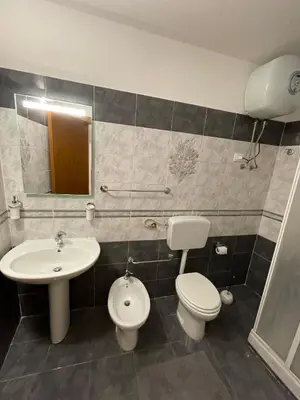 a bathroom with a sink and a toilet and a mirror at Sicooli apartments via Materassai 46 in Palermo