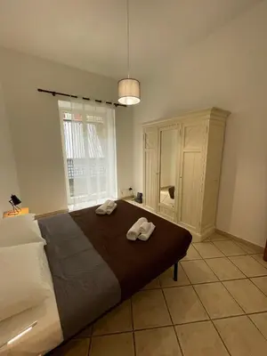 a bedroom with a large bed with two towels on it at Sicooli apartments via Materassai 46 in Palermo