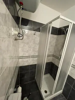 a shower with a glass door in a bathroom at Sicooli apartments via Materassai 46 in Palermo