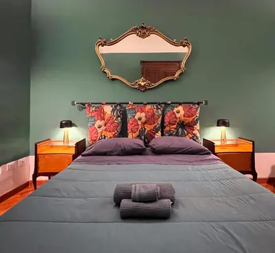 a bedroom with a large bed with a mirror on the wall at Le Radici casa vacanze in Palermo