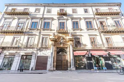 a large white building with a large door at Le Radici casa vacanze in Palermo
