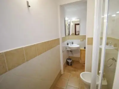a bathroom with a shower and a sink and a toilet at Vecchio Cortile Home Holidays in Palermo